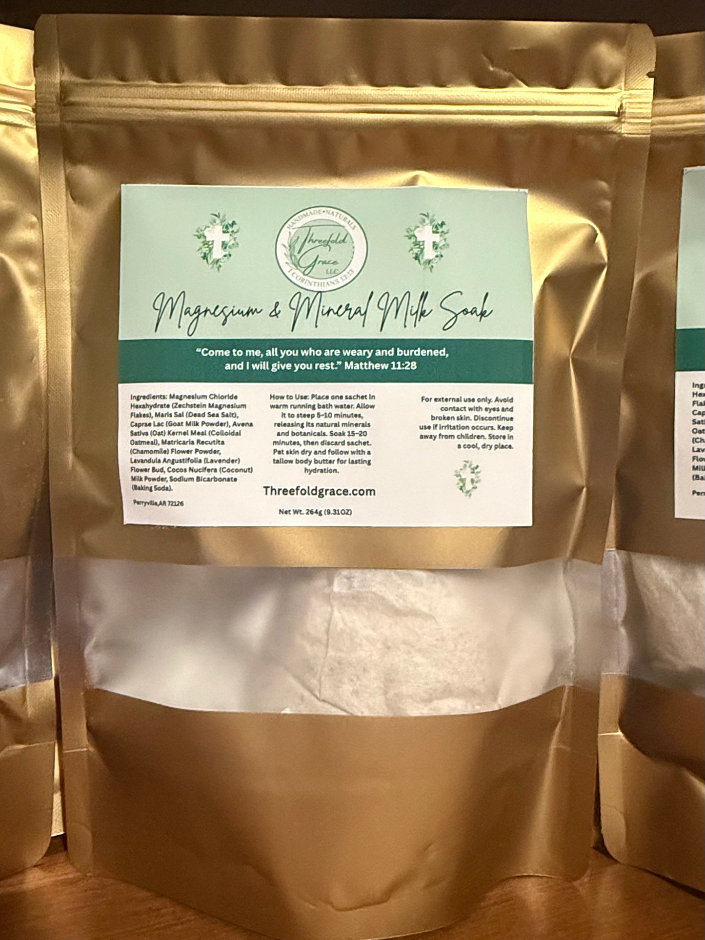 Gold packaging of a magnesium and mineral milk soak with a label on a wooden surface