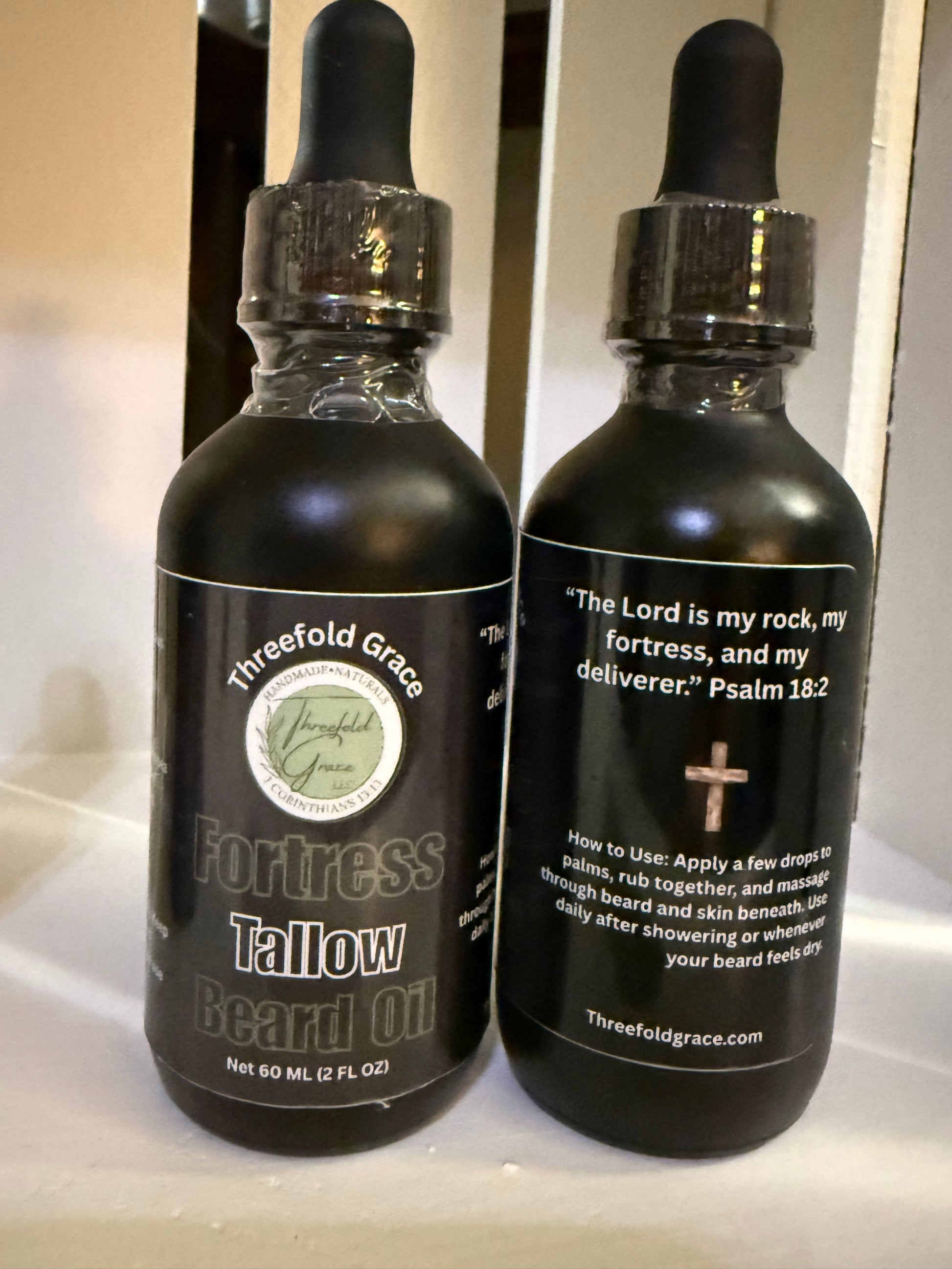 tallow beard oil in black glass dropper for softening beards palo santo