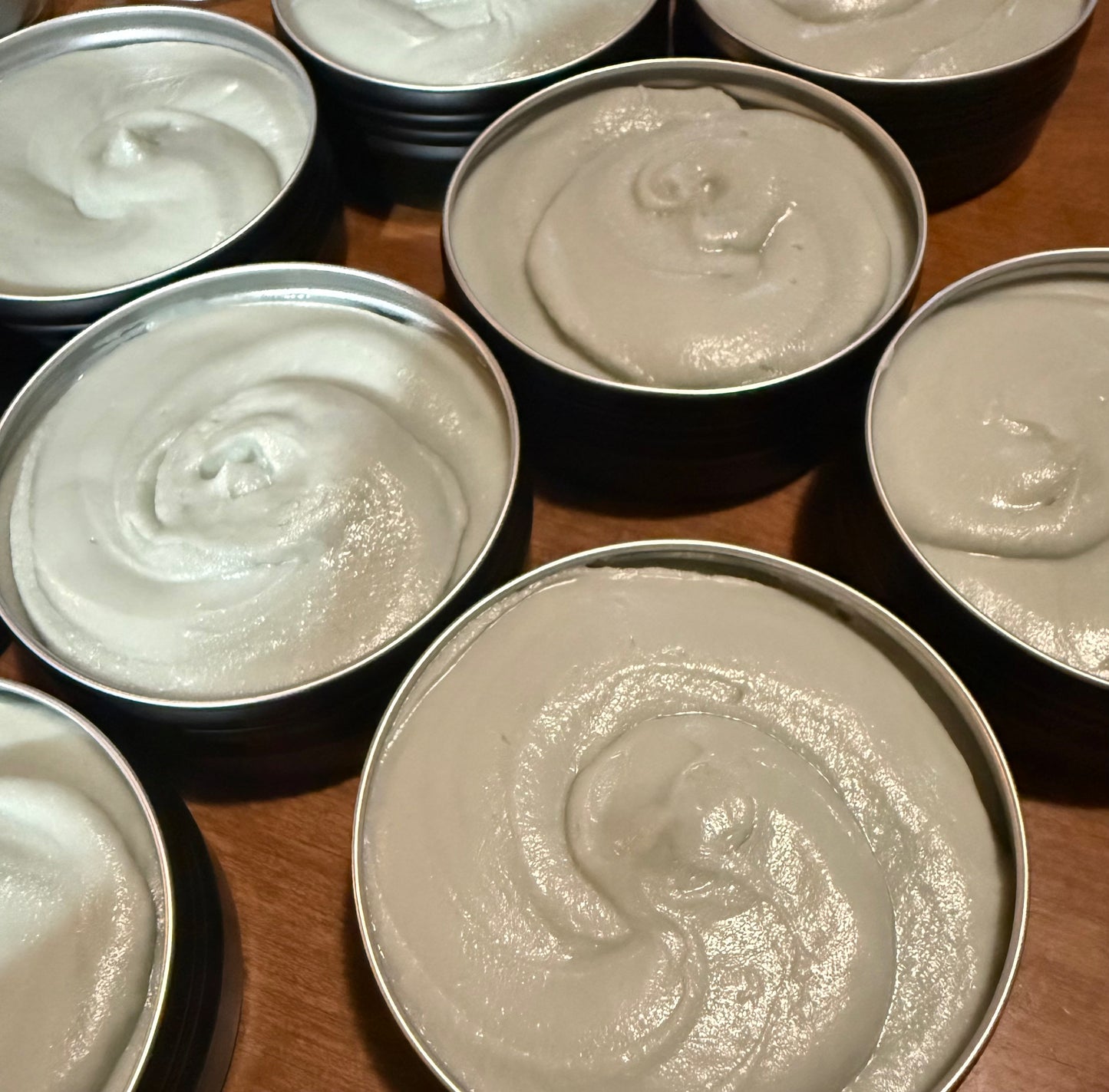 Multiple tins of green magnesium tallow cream used for  pain