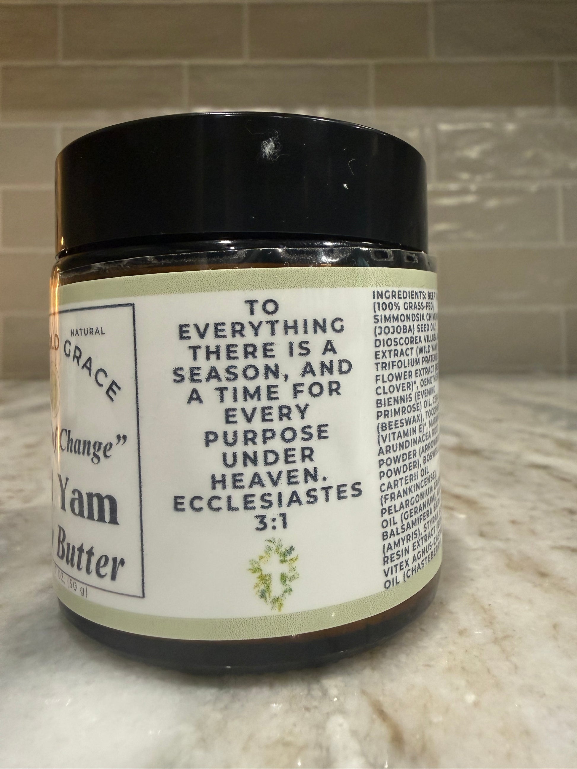 Jar of wild yam butter with a label on a tiled surface